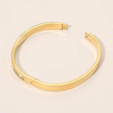 Stainless Steel CZ Accent Quatrefoil Engraved Hinged Bangle Bracelet