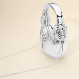 Hard Shell Metallic Sculpted Loop Top Handle Handbag