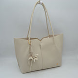 Minimalist Structured Tote Bag with Geometric Cutout and Tassel Accent