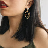 abstract hollow face drop earrings